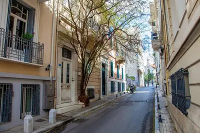 an empty street in a city with buildings at TONI'S Cosy Apartment next to Syntagma Square in Athens