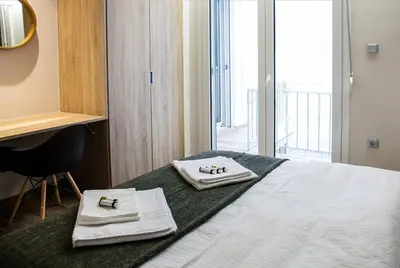 a hotel room with a bed with towels on it at TONI'S Cosy Apartment next to Syntagma Square in Athens