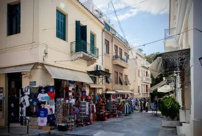 a street with shops and stores in a city at TONI'S Cosy Apartment next to Syntagma Square in Athens