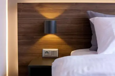 a bedroom with a head board with a bed and a light at TONI'S Home for couples or business Travellers 1BD in Athens