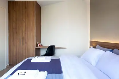 a bedroom with a bed with two towels on it at TONI'S Home for couples or business Travellers 1BD in Athens