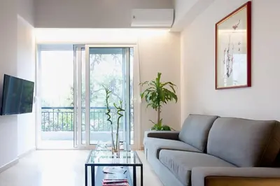 a living room with a couch and a glass table at TONI'S Home for couples or business Travellers 1BD in Athens