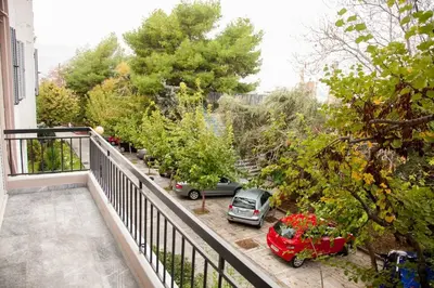 a balcony with two cars parked on a street at TONI'S Home for couples or business Travellers 1BD in Athens