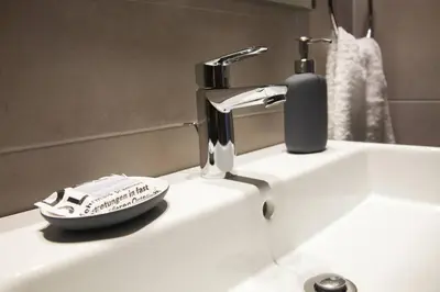 a bathroom sink with a faucet and a phone at TONI'S Home for couples or business Travellers 1BD in Athens