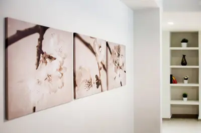 a hallway with a row of art on the wall at TONI'S Spacious Apartment next to Acropolis Museum in Athens