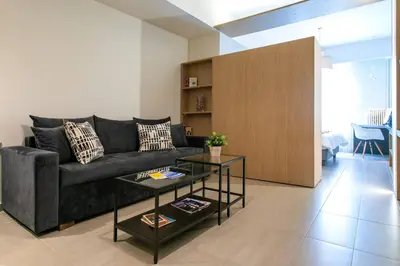 a living room with a couch and a table at TONI'S Studio Syntagma, 1 min from Metro station in Athens