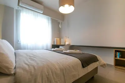 a bedroom with a large bed and a window at TONI'S Studio Syntagma, 1 min from Metro station in Athens