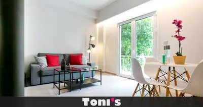 a living room with a couch and a table at TONI'S Local retreat for Magicians in Koukaki in Athens