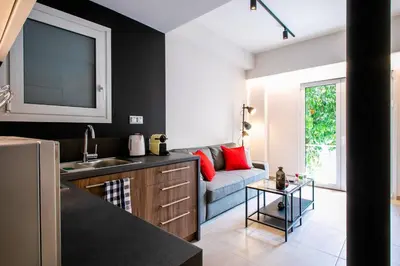 a kitchen and living room with a couch at TONI'S Local retreat for Magicians in Koukaki in Athens