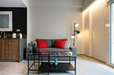 a living room with a couch and a table at TONI'S Local retreat for Magicians in Koukaki in Athens