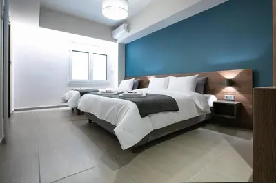 a bedroom with a large bed with a blue wall at TONI'S Local retreat for Magicians in Koukaki in Athens
