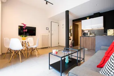 a living room with a couch and a table at TONI'S Local retreat for Magicians in Koukaki in Athens