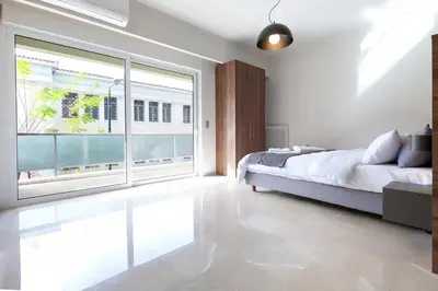 a bedroom with a bed and a large window at TONI'S Grande Home next to A.Museum in Athens