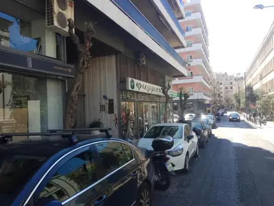 a row of cars parked on the side of a street at TONI'S Grande Home next to A.Museum in Athens