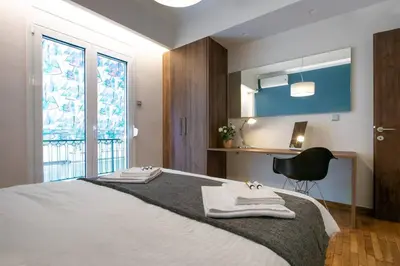 a bedroom with a bed with towels on it at TONI'S 2BD Stay in Charming Historical centre in Athens