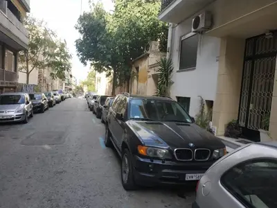 a black car parked on the side of a street at TONI'S 2BD Stay in Charming Historical centre in Athens