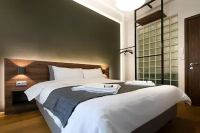 a bedroom with a large bed with two towels on it at TONI'S 2BD Stay in Charming Historical centre in Athens