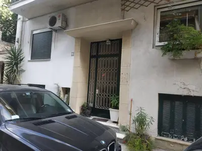 a black car parked in front of a house at TONI'S 2BD Stay in Charming Historical centre in Athens