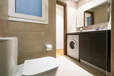 a bathroom with a toilet and a washing machine at TONI'S 2BD Stay in Charming Historical centre in Athens