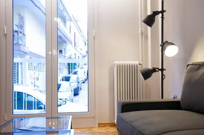 a living room with a couch and a glass table at TONI'S 2BD Modern flat in Koukaki near Acropoli in Athens
