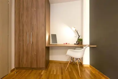 a white chair sitting next to a desk in a room at TONI'S 2BD Modern flat in Koukaki near Acropoli in Athens