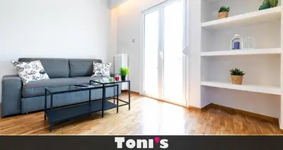 a living room with a couch and a table at TONI'S 2BD Home for Superman and Superwoman. in Athens