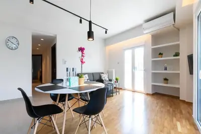 a dining room and living room with a table and chairs at TONI'S 2BD Home for Superman and Superwoman. in Athens