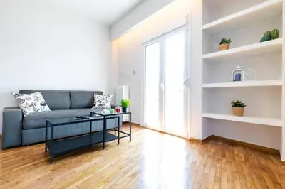 a living room with a couch and a table at TONI'S 2BD Home for Superman and Superwoman. in Athens