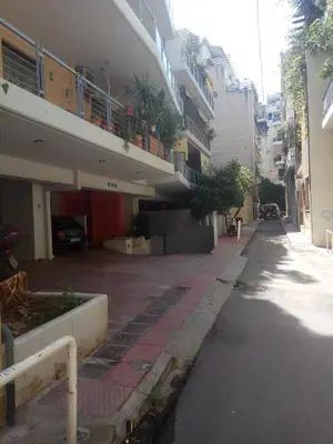 an empty street in front of a building at TONI'S STUDIO for couples near ACROPOLIS Museum in Athens