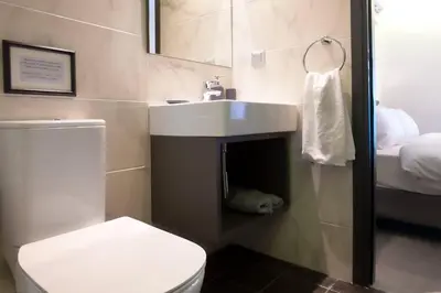a bathroom with a white sink and a toilet at TONI'S STUDIO for couples near ACROPOLIS Museum in Athens