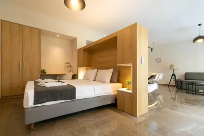 a bedroom with a large bed and a couch at TONI'S makes you an offer, you cannot refuse. in Athens