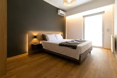 a bedroom with a bed and a large window at TONI'S makes you an offer, you cannot refuse. in Athens