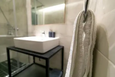 a bathroom with a sink and a mirror and a shower at TONI'S makes you an offer, you cannot refuse. in Athens