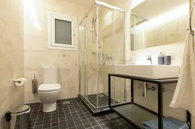 a bathroom with a toilet and a sink and a shower at TONI'S makes you an offer, you cannot refuse. in Athens
