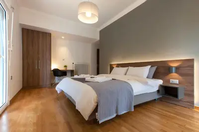 a large bedroom with a large bed and a desk at TONI'S 3BD Amazing Home for Wizards and families! in Athens
