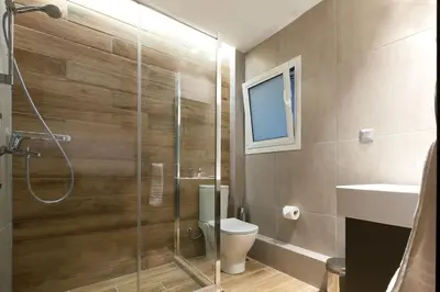 a bathroom with a shower and a toilet and a sink at TONI'S 3BD Amazing Home for Wizards and families! in Athens