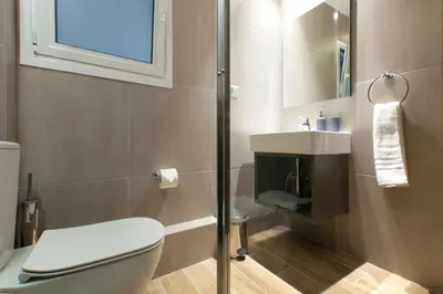 a bathroom with a toilet and a sink and a shower at TONI'S 3BD Amazing Home for Wizards and families! in Athens