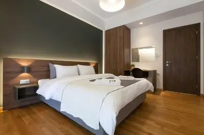 a bedroom with a large white bed and wooden floors at TONI'S 3BD Amazing Home for Wizards and families! in Athens