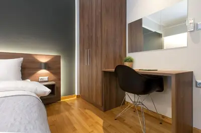 a bedroom with a bed and a desk and a chair at TONI'S 3BD Amazing Home for Wizards and families! in Athens