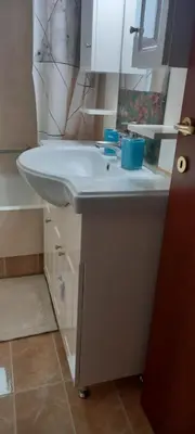 a bathroom with a white sink and a mirror at Vasi in Markopoulo