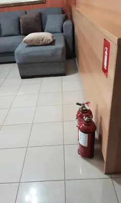 a fire hydrant sitting on a tile floor next to a couch at Vasi in Markopoulo
