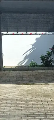 a shadow of a woman on the side of a building at Vasi in Markopoulo