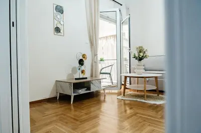 a white living room with a table and a table sidx sidx sidx at luxury apartment center athens (wifi) in Athens