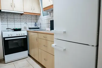 a kitchen with a white stove and a white refrigerator at luxury apartment center athens (wifi) in Athens