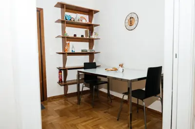 a dining room table and chairs in a room at luxury apartment center athens (wifi) in Athens