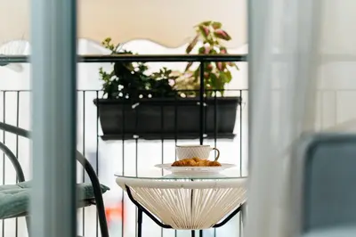 a table with a cup and a plate of food on it at luxury apartment center athens (wifi) in Athens