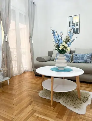 a living room with a vase of flowers on a table at luxury apartment center athens (wifi) in Athens