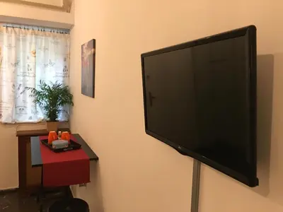 a flat screen tv hanging on a wall at Edem Riviera Studio,close to beach,in Paleo Faliro in Athens