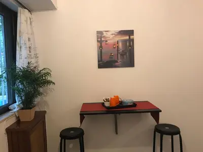a table in a room with two stools and a table at Edem Riviera Studio,close to beach,in Paleo Faliro in Athens
