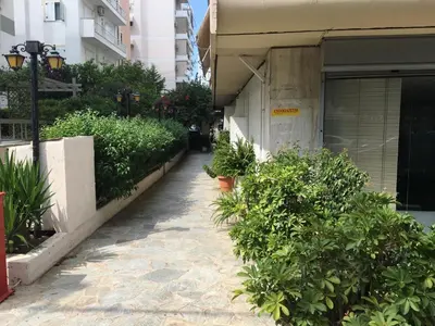 a walkway with plants on the side of a building at Edem Riviera Studio,close to beach,in Paleo Faliro in Athens
